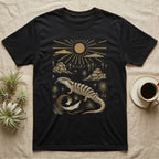 Blue-Tongued Skink Home Range T-Shirt in Black — Woodcut-style illustration of a blue-tongued skink walking across bare soil with its tongue out, shed skin and grass trees behind, no on-shirt text.