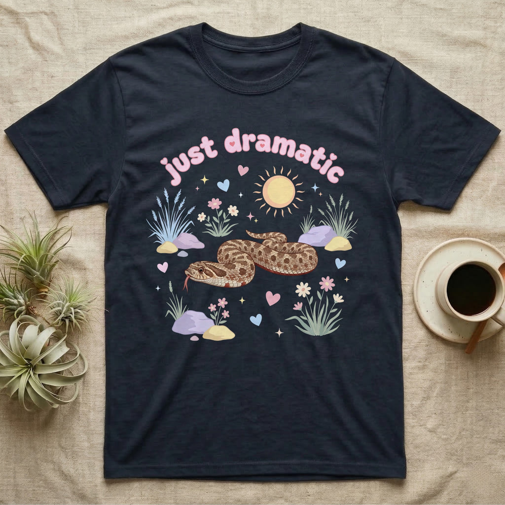 Western Hognose Snake Baby T-Shirt in Navy — Pastel western hognose snake in a low coil with tongue out among grasses, puffy pink bubble wordmark "just dramatic" above.