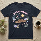 Western Hognose Snake Baby T-Shirt in Navy — Pastel western hognose snake in a low coil with tongue out among grasses, puffy pink bubble wordmark "just dramatic" above.