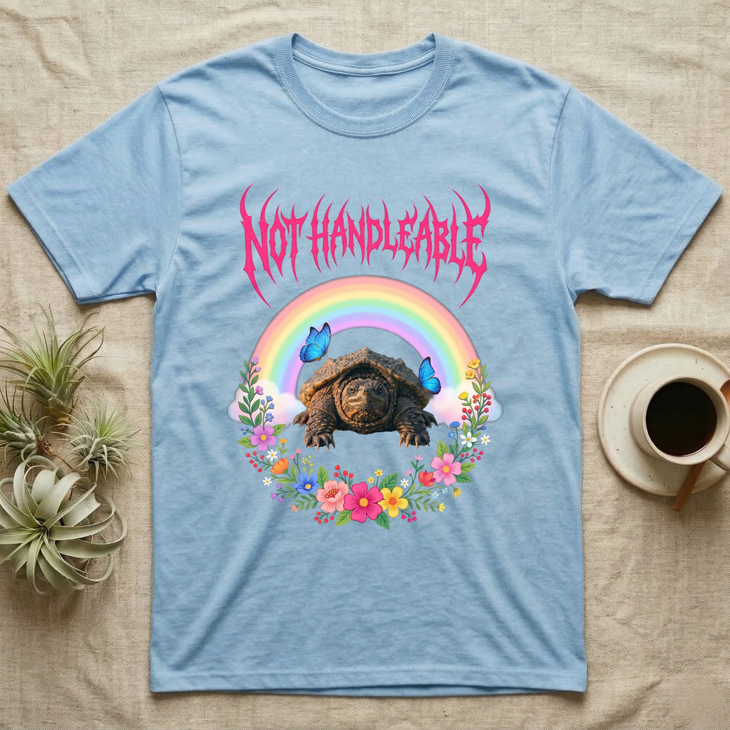 Snapping Turtle Hatchling T-Shirt in Light Blue — Cute baby snapping turtle in a pastel rainbow and flower wreath under a hot pink metal logo reading NOT HANDLEABLE