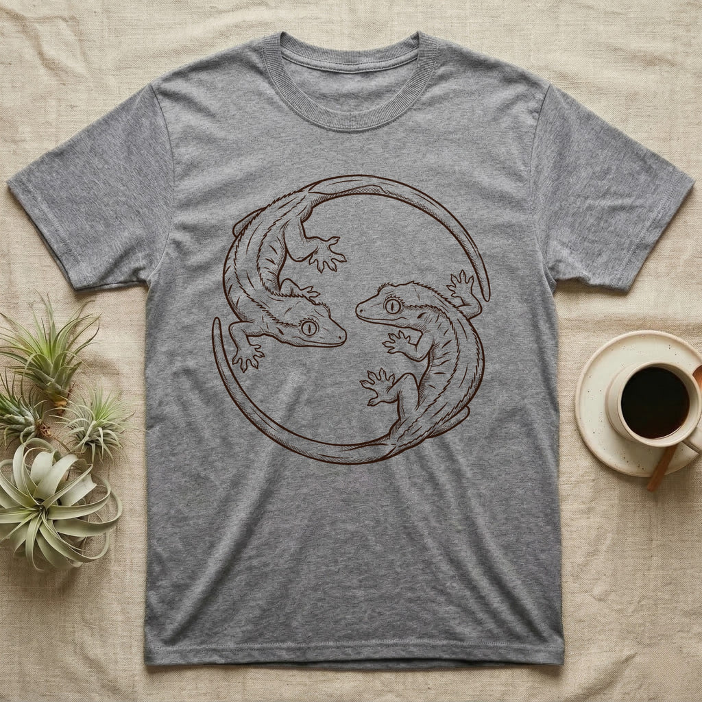 Crested Gecko Roundel T-Shirt in Sport Grey — Two crested geckos in mahogany brush line art, rotated 180 degrees into a circular roundel closed by their own tails.