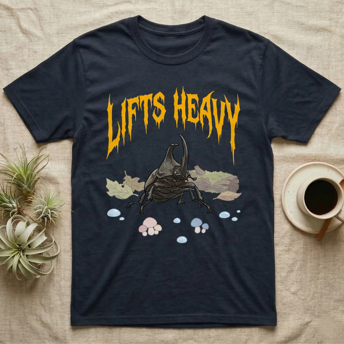 Rhino Beetle Feral T-Shirt in Navy — Horned rhinoceros beetle standing head-on below a dripping amber-gold metal "Lifts Heavy" wordmark