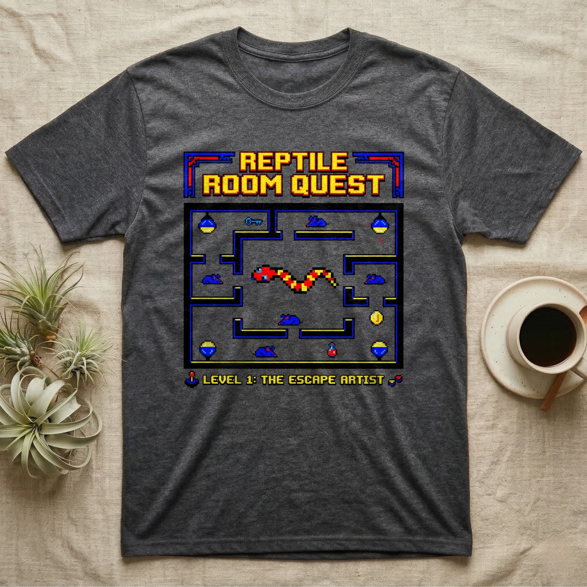 Dark grey t-shirt with "Reptile Room Quest Level 1: The Escape Artist" video game design.