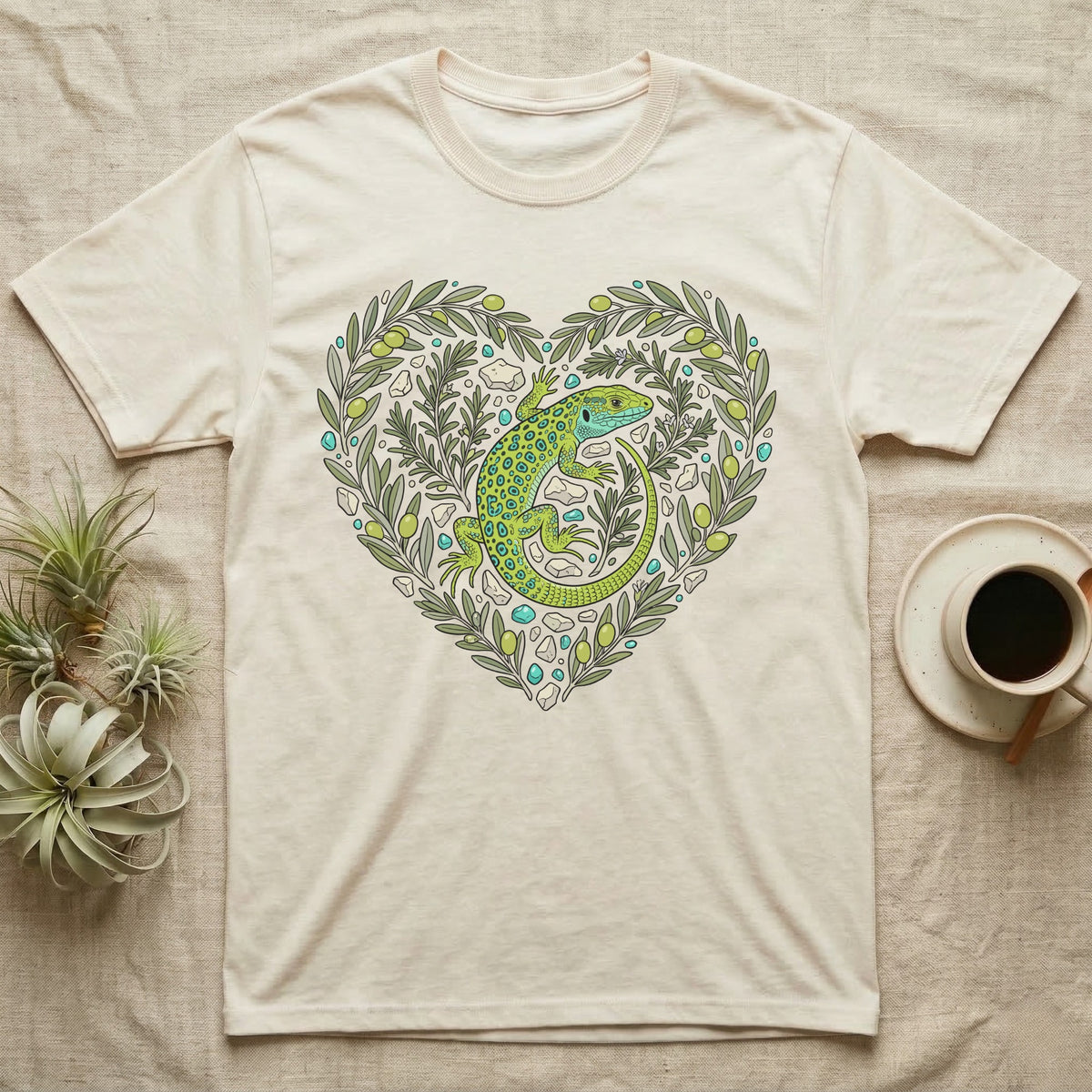 Cream t-shirt with green lizard and olive branch heart graphic.