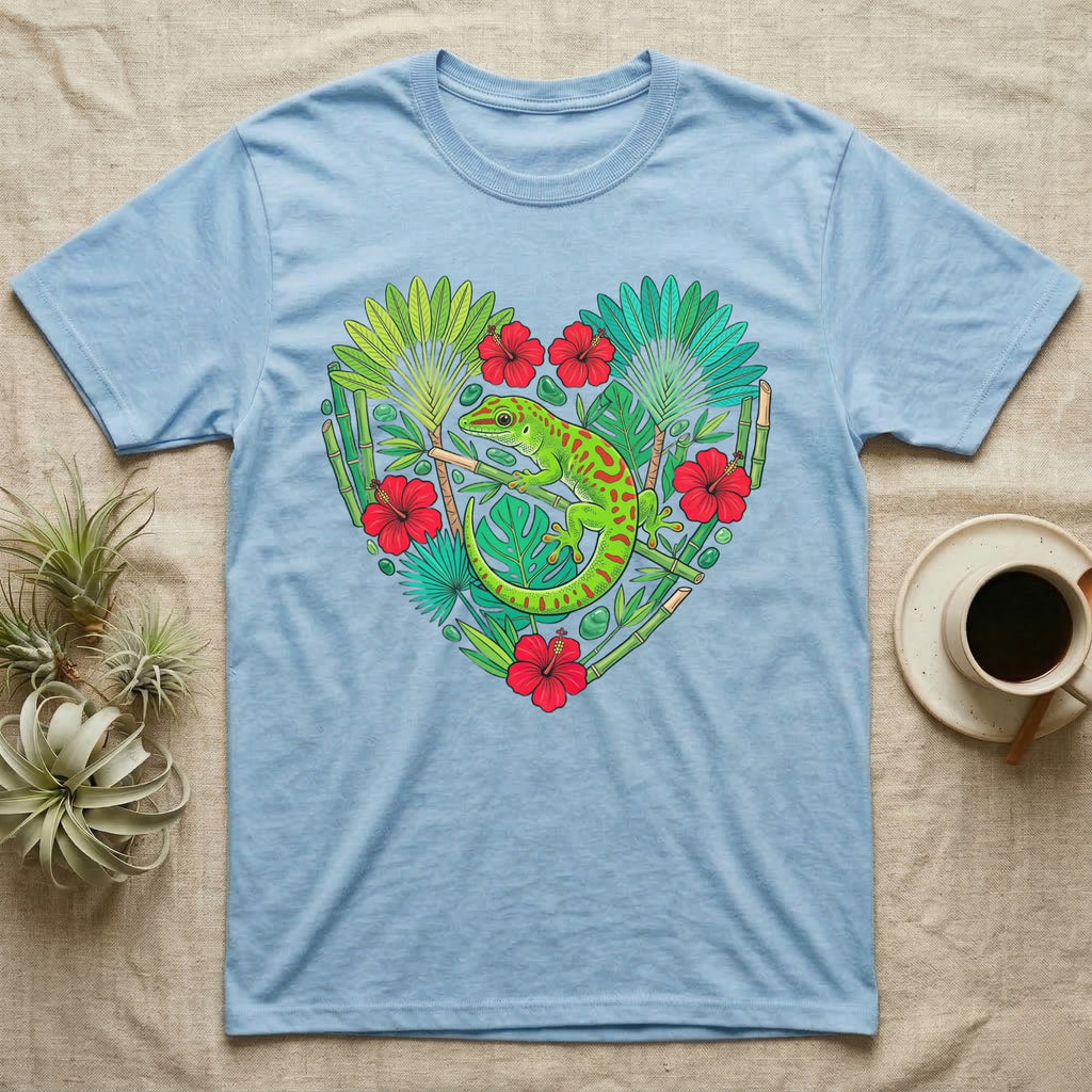 Light blue t-shirt with a green gecko and tropical plants in a heart shape.