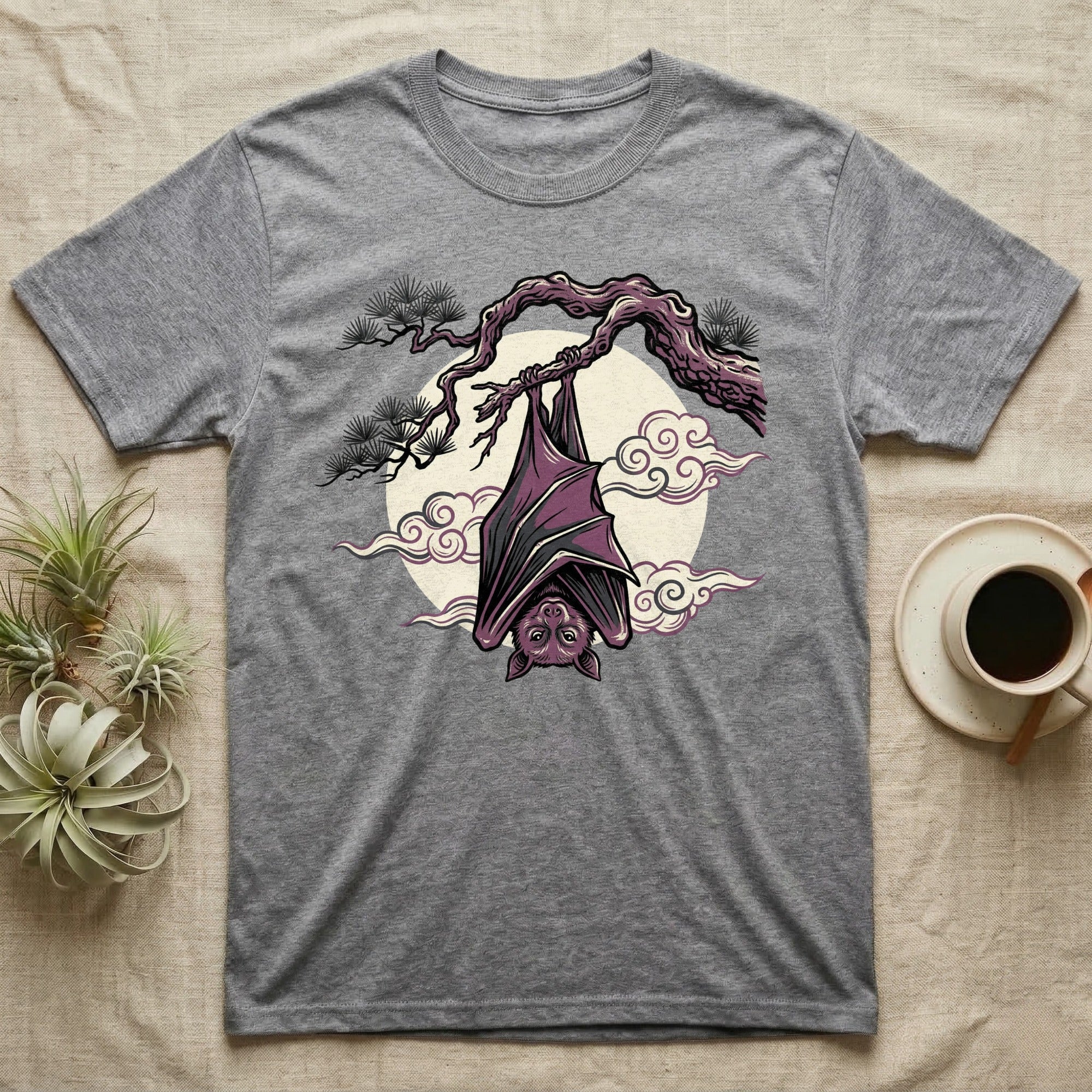 Grey t-shirt with a purple bat hanging upside down from a branch.