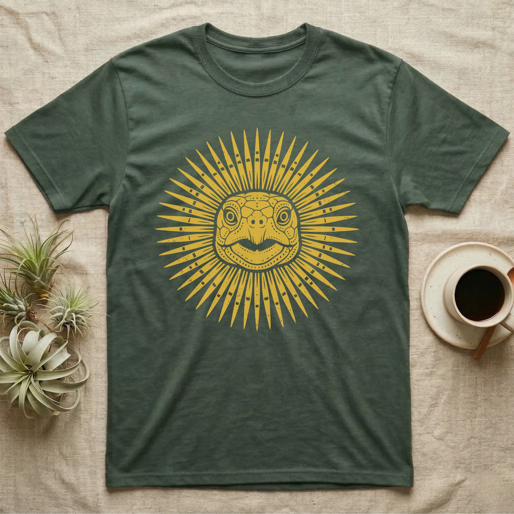 Hermann's Tortoise Sunburst T-Shirt in Military Green — Horn-yellow woodblock Hermann's tortoise seen head-on, its shell scutes radiating outward into a sunburst medallion.