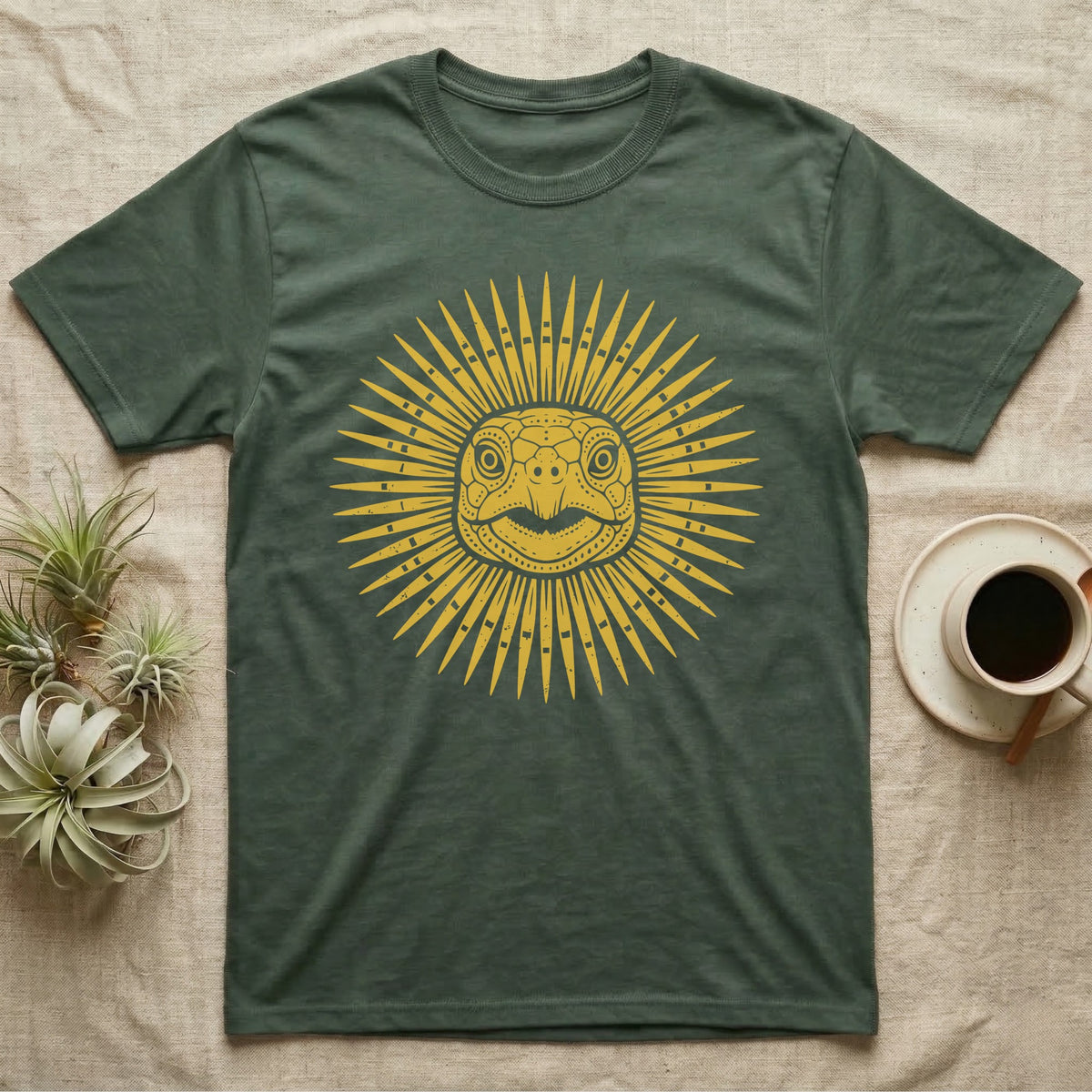 Hermann's Tortoise Sunburst T-Shirt in Military Green — Horn-yellow woodblock Hermann's tortoise seen head-on, its shell scutes radiating outward into a sunburst medallion.