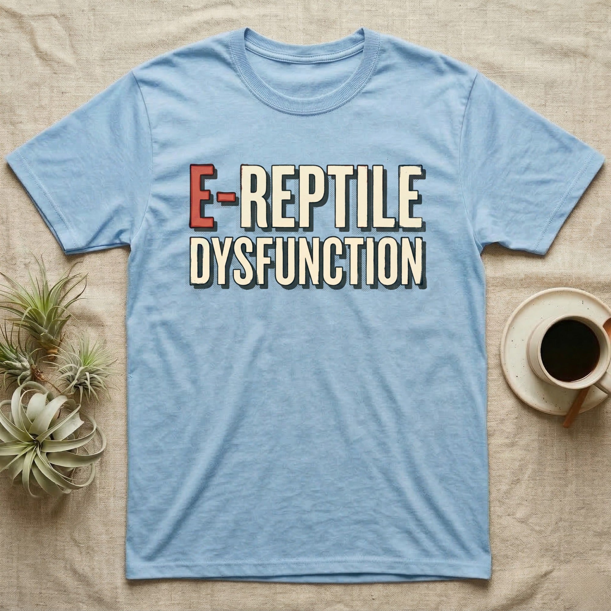 E-Reptile Dysfunction Gecko T-Shirt in Light Blue — Retro-pharmacy typographic wordmark reading "E-Reptile Dysfunction" in distressed cream and tomato-red lettering.