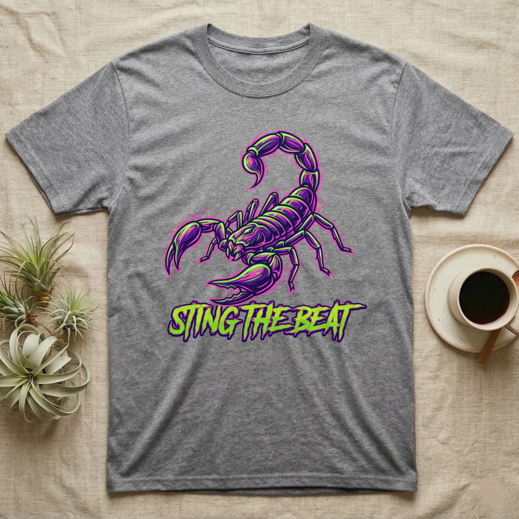 Gray t-shirt with a purple and green scorpion graphic and "STING THE BEAT" text.