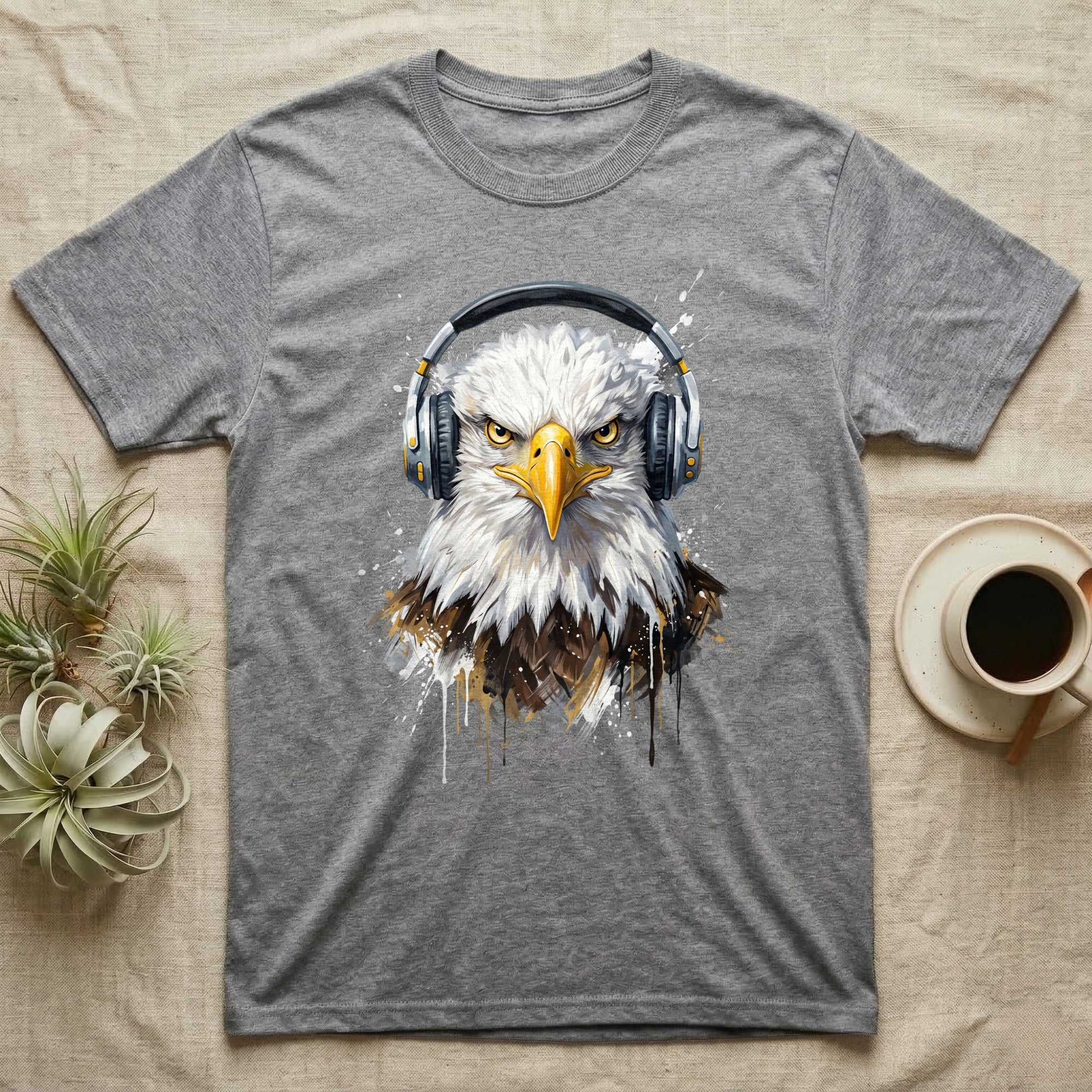 Bald eagle wearing headphones, front view, on a grey t-shirt.