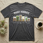 Reptile Terrarium Hobbies T-Shirt in Dark Heather — Watercolour row of reptile vivariums with a snake, dart frog, gecko, bearded dragon, tree frog and a cricket bin under MANY HOBBIES, each labelled carpentry to bug farming
