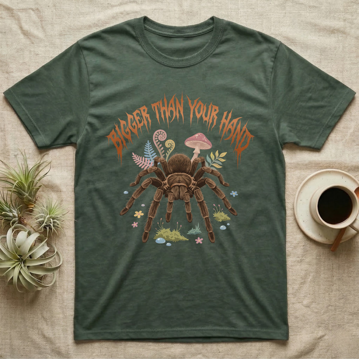 Goliath Birdeater Feral T-Shirt in Military Green — Goliath birdeater tarantula with bristly legs spread under jagged copper metal text BIGGER THAN YOUR HAND