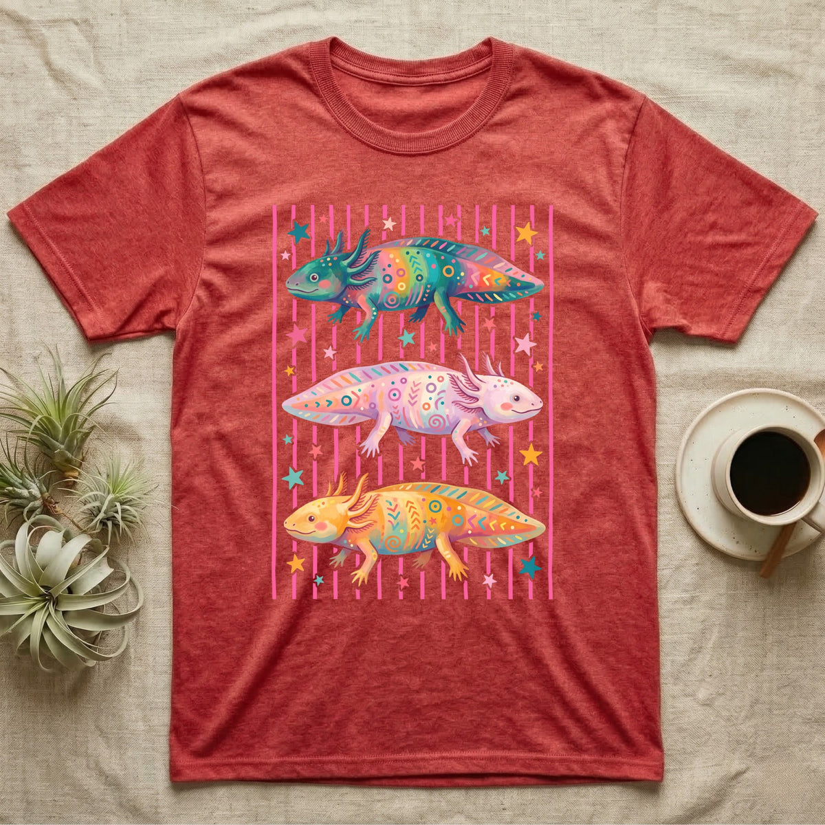 Axolotl Colourways Candy Stripe T-Shirt in Heather Red — Three gouache axolotls stacked in bands on pink candy stripes, facing left, right and left, with scattered stars