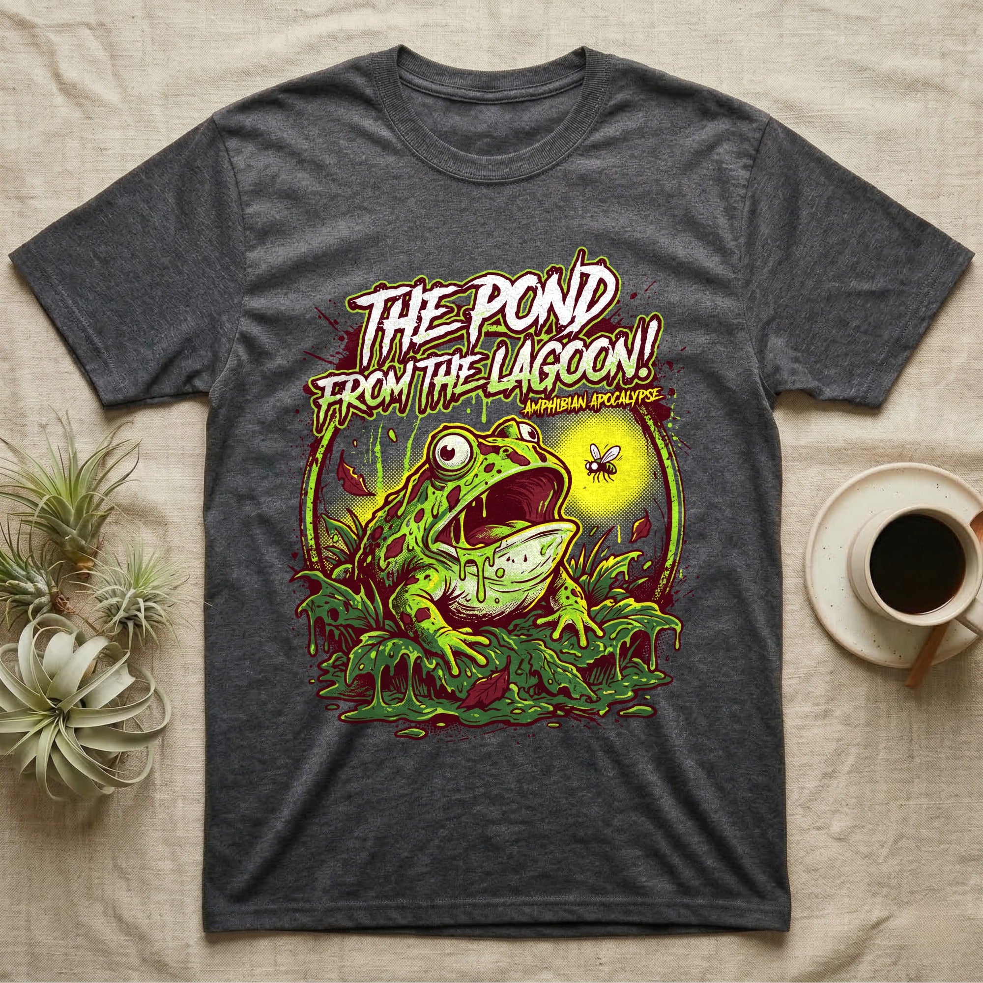 Pacman Frog Lagoon Apocalypse T-Shirt in Dark Heather — B-movie horror poster of a Pacman frog bursting from slime at a fly, "The Pond From the Lagoon, Amphibian Apocalypse."