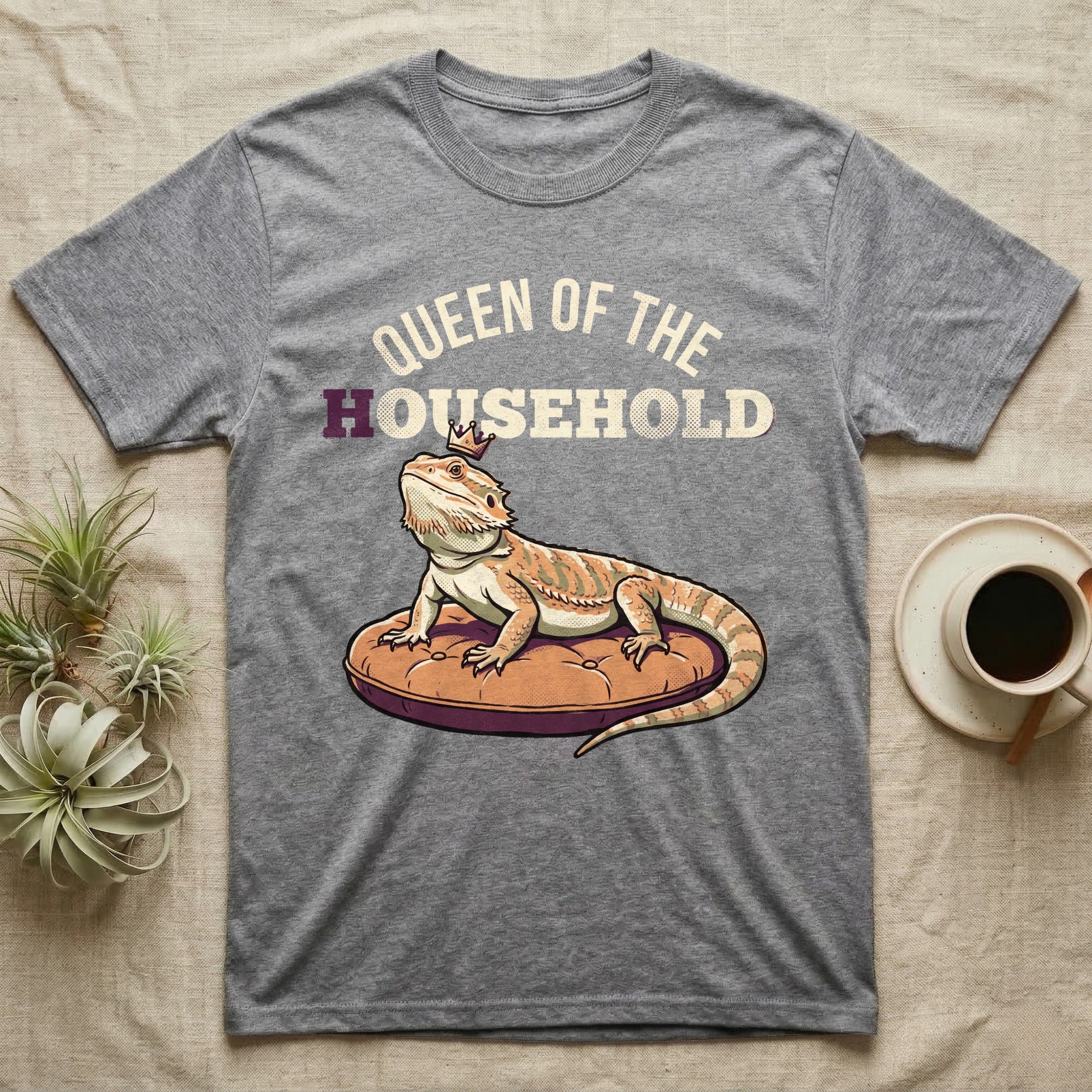 Queen Bearded Dragon T-Shirt in Sport Grey — Bold-vector illustration of a bearded dragon on a throne-cushion with a crown under varsity Queen of the Household lettering.