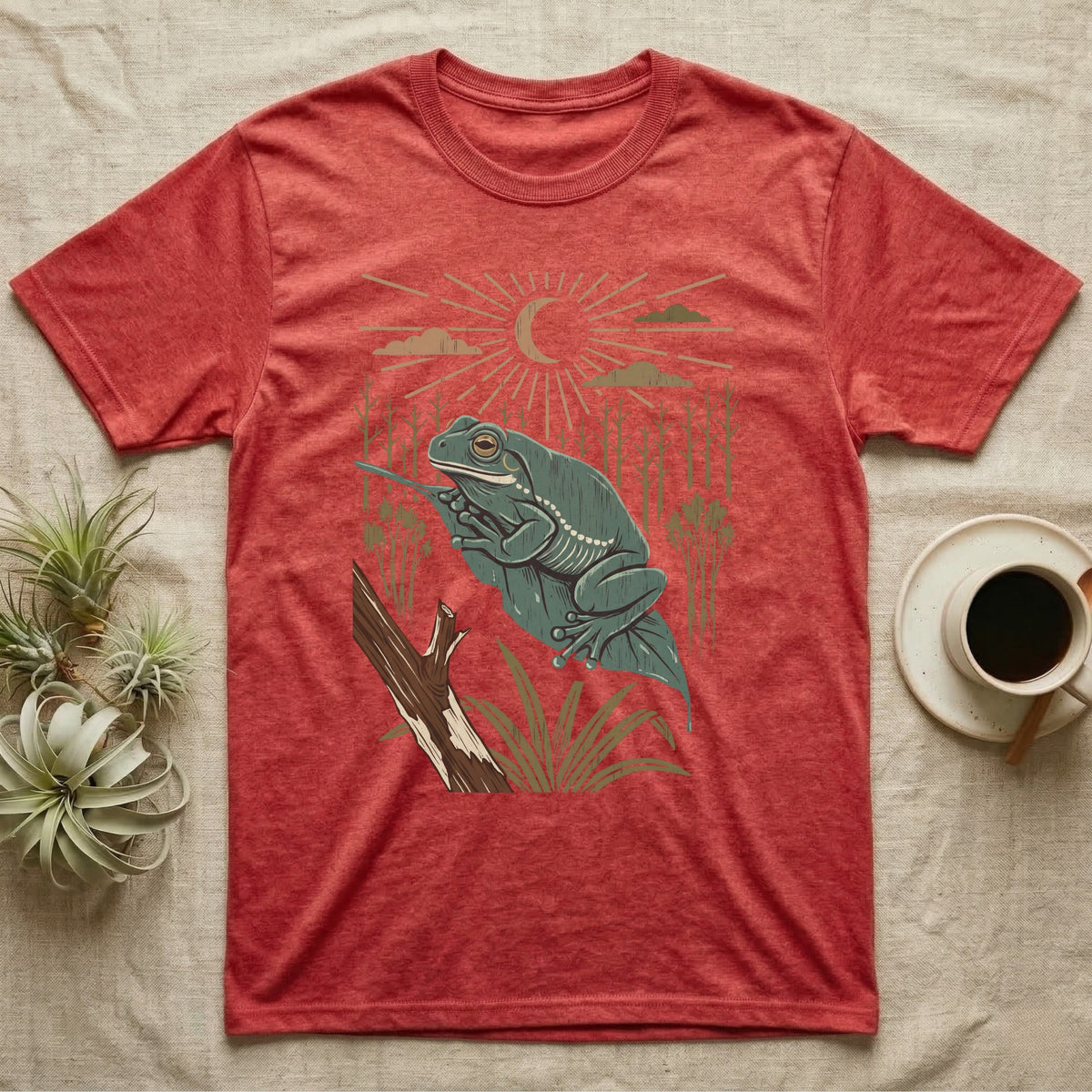 White's Tree Frog Home Range T-Shirt in Heather Red — Woodcut-style illustration of a White's tree frog resting on a broad wet leaf with reed stems and a crescent moon behind, no on-shirt text.