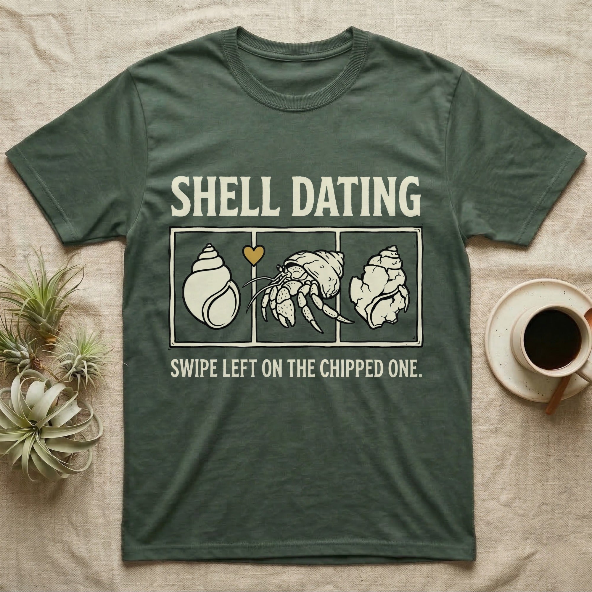 Hermit Crab Shell Dating T-Shirt in Military Green — Vintage-ink hermit crab leaning toward a pristine shell, chipped shell on the right, carved type "Shell Dating. Swipe Left."