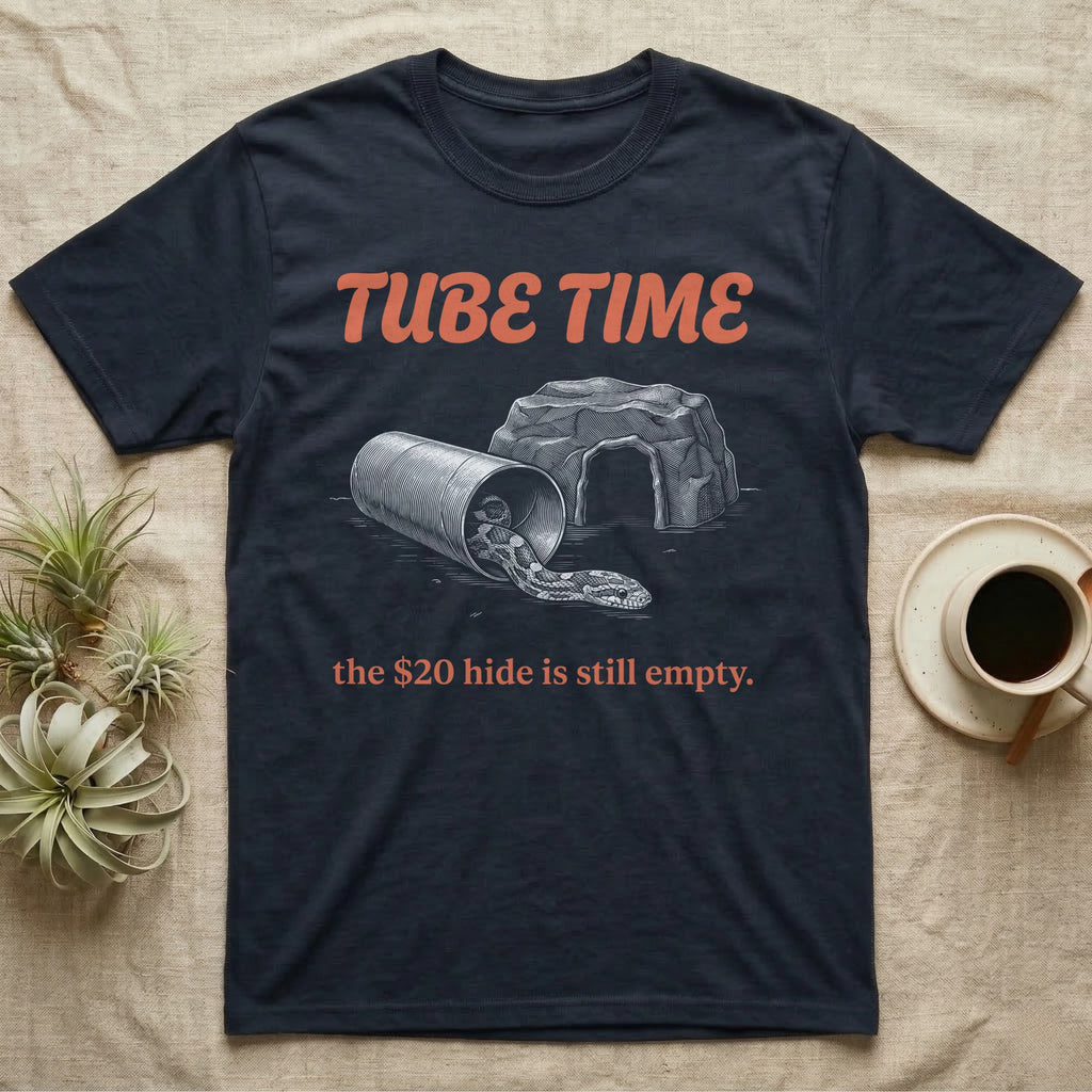 Corn Snake Tube T-Shirt in Navy — Engraved corn snake lounging in a cardboard tube beside an empty rock hide, under retro script reading TUBE TIME.