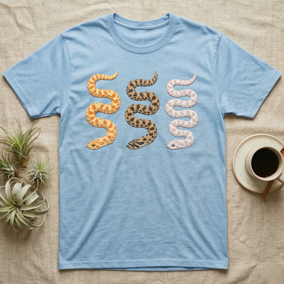 Hognose Morph Triptych T-Shirt in Light Blue — Palette-knife painting of three western hognose snakes side by side, albino, anaconda and snow morphs.
