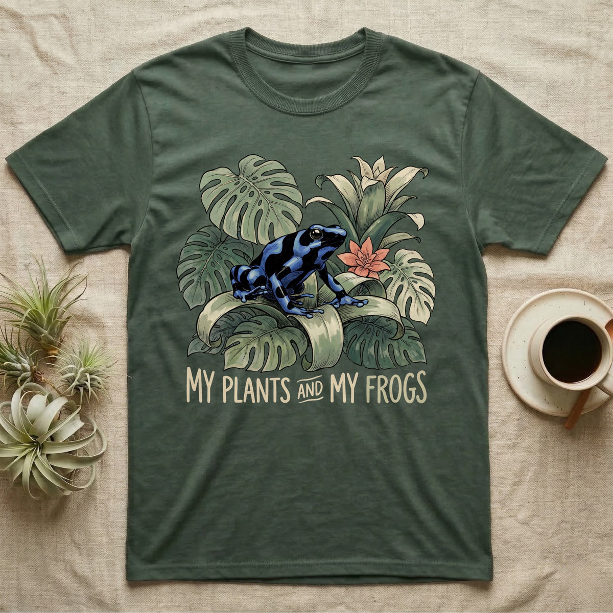 Plants And Frogs T-Shirt in Military Green — Naturalist-plate illustration of a dart frog perched in lush foliage with hand-lettered text reading My Plants And My Frogs.