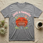 Tomato Frog Softie T-Shirt in Sport Grey — Round red-orange tomato frog facing forward under a puffy pastel "just a tomato" bubble wordmark with tiny hearts.