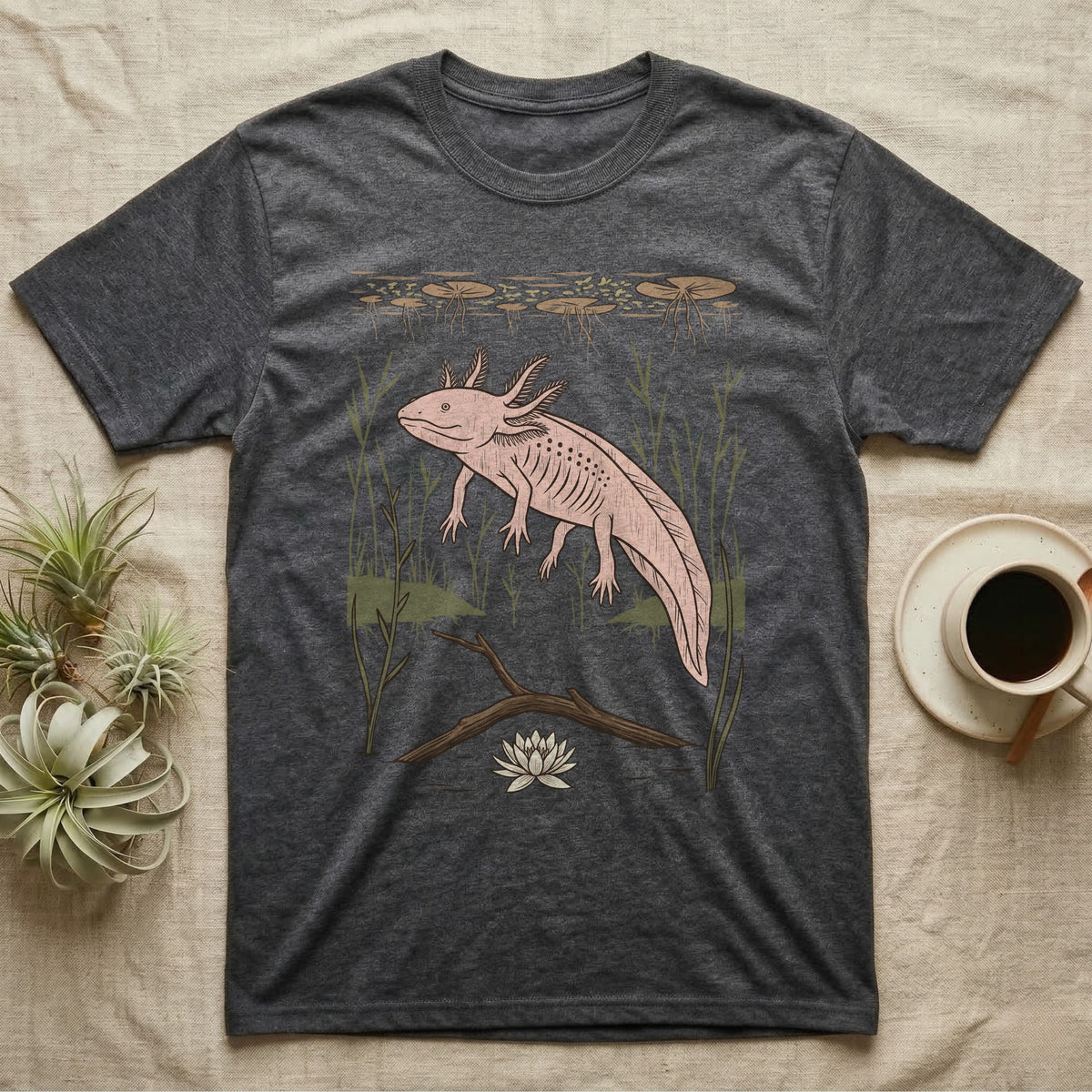 Axolotl Home Range T-Shirt in Dark Heather — Woodcut-style illustration of an axolotl drifting among reeds and lily pads in a Xochimilco canal, no on-shirt text.