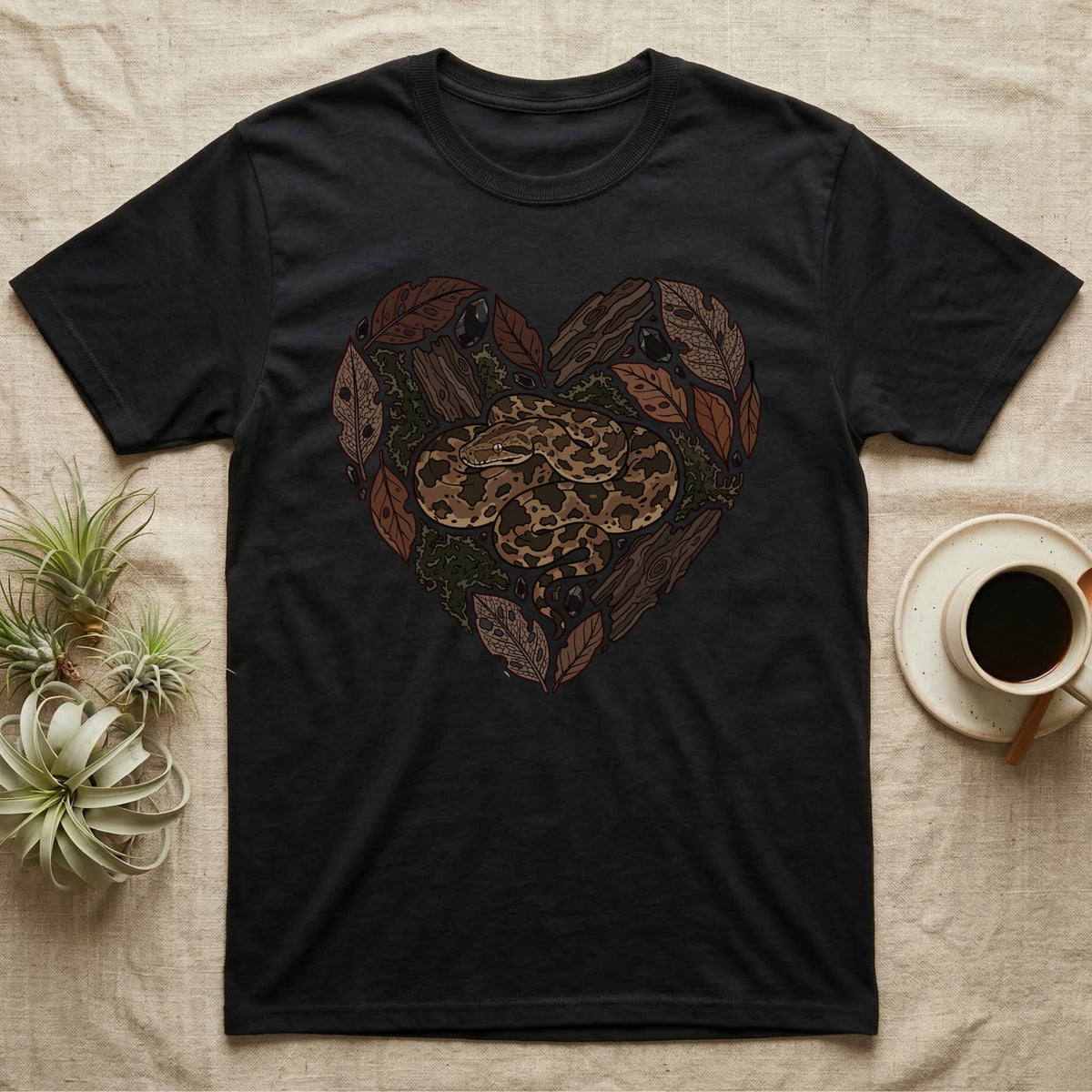 Black t-shirt with heart-shaped snake and natural elements design.