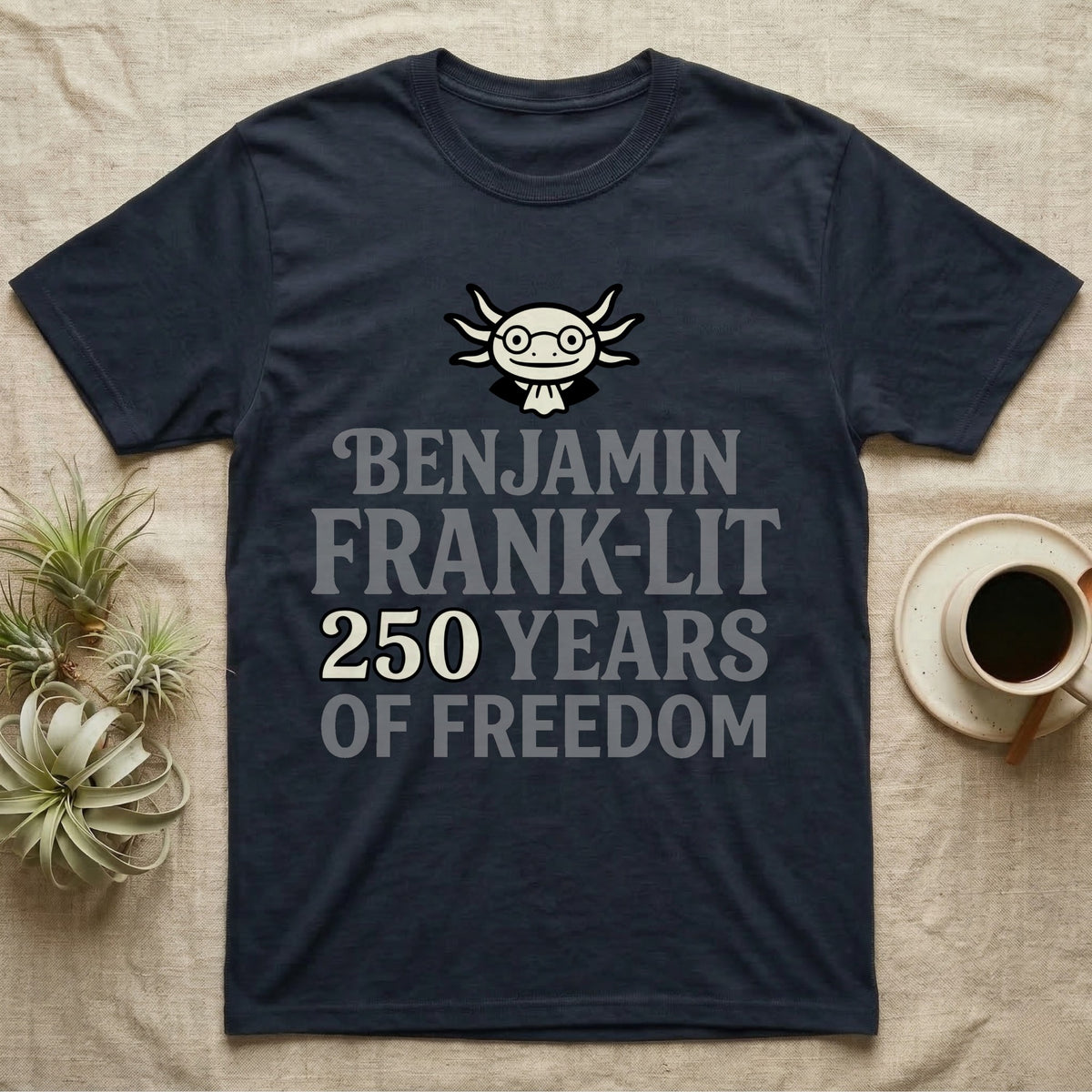 Axolotl Benjamin Franklin T-Shirt in Navy — Flat cream axolotl as Ben Franklin in glasses above bold text reading Benjamin Frank-Lit, 250 Years of Freedom.