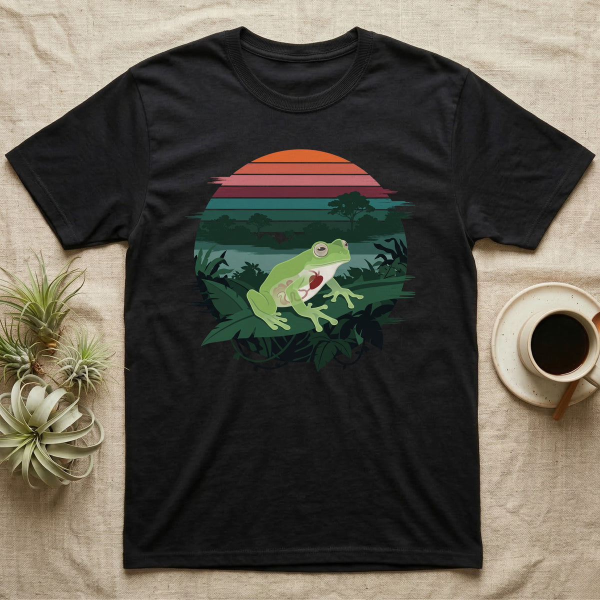 Glass Frog See-Through T-Shirt in Black — Flat-colour circle-window illustration of a glass frog silhouetted crossing a rainforest canopy scene.
