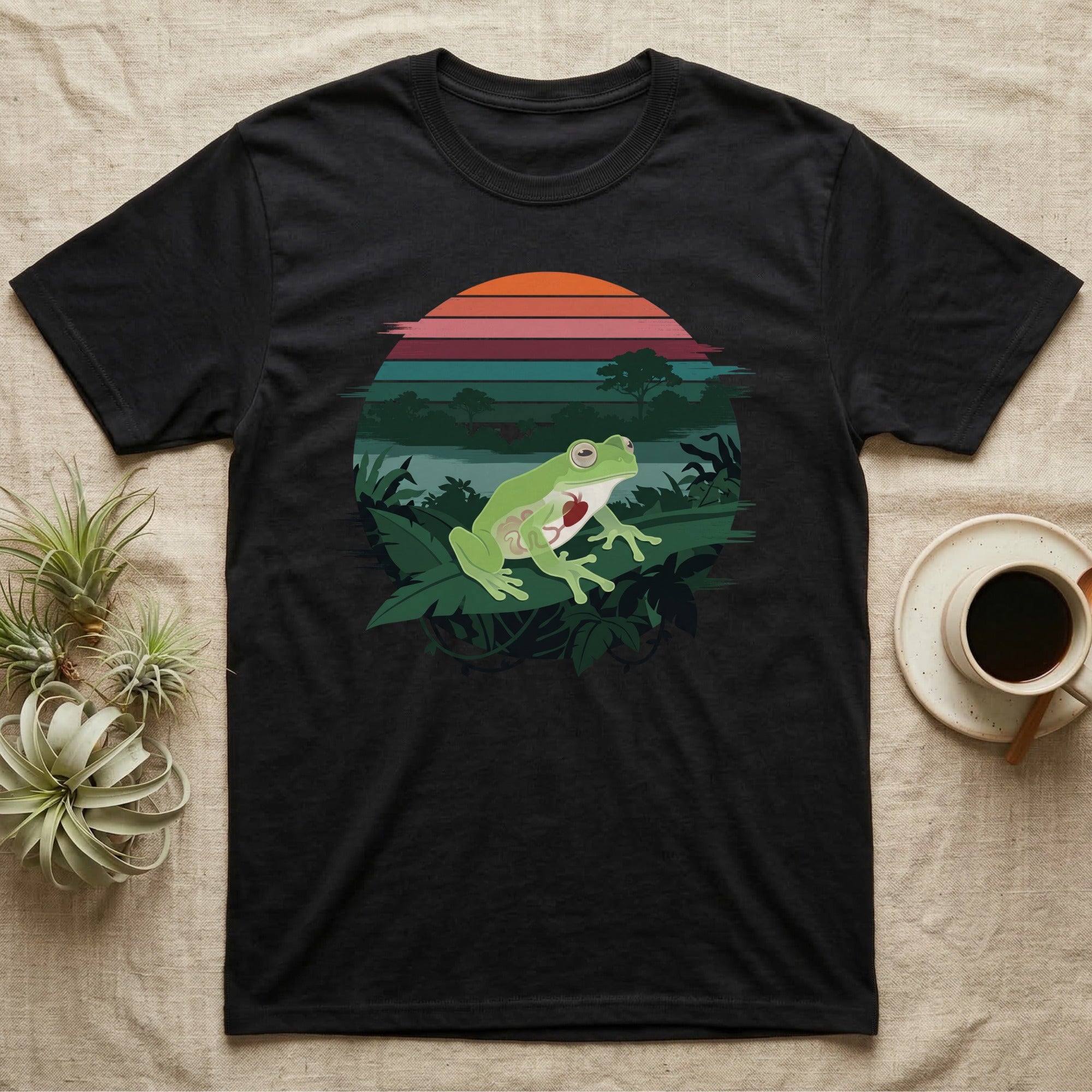 Glass Frog See-Through T-Shirt in Black — Flat-colour circle-window illustration of a glass frog silhouetted crossing a rainforest canopy scene.
