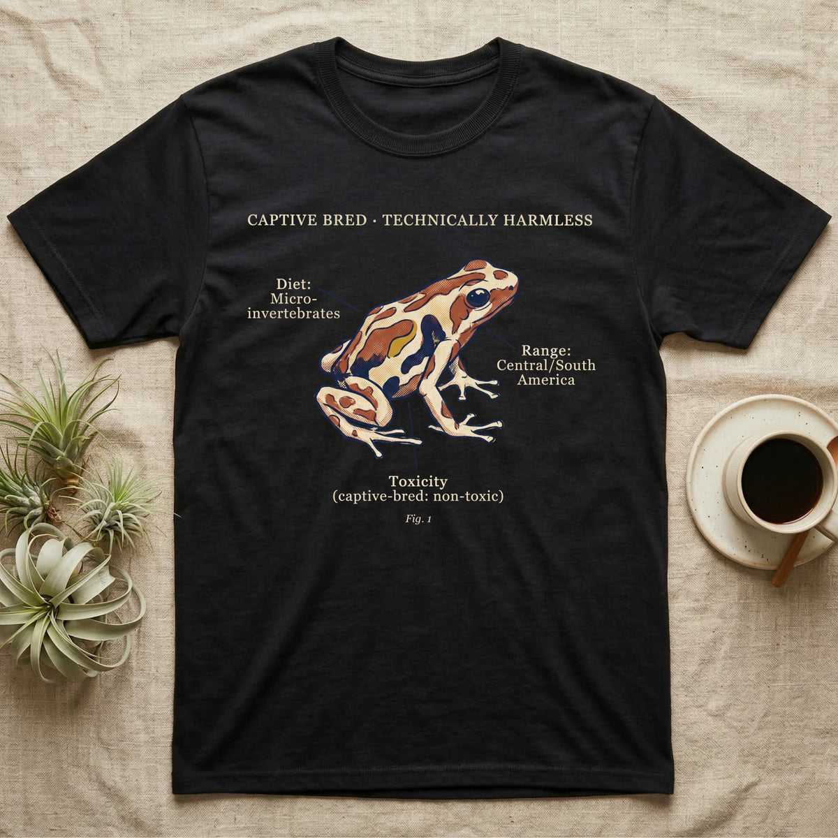 Captive Bred Dart Frog T-Shirt in Black — Retro science-plate illustration of a labeled dart frog with field-guide callouts and a captive-bred non-toxic note.