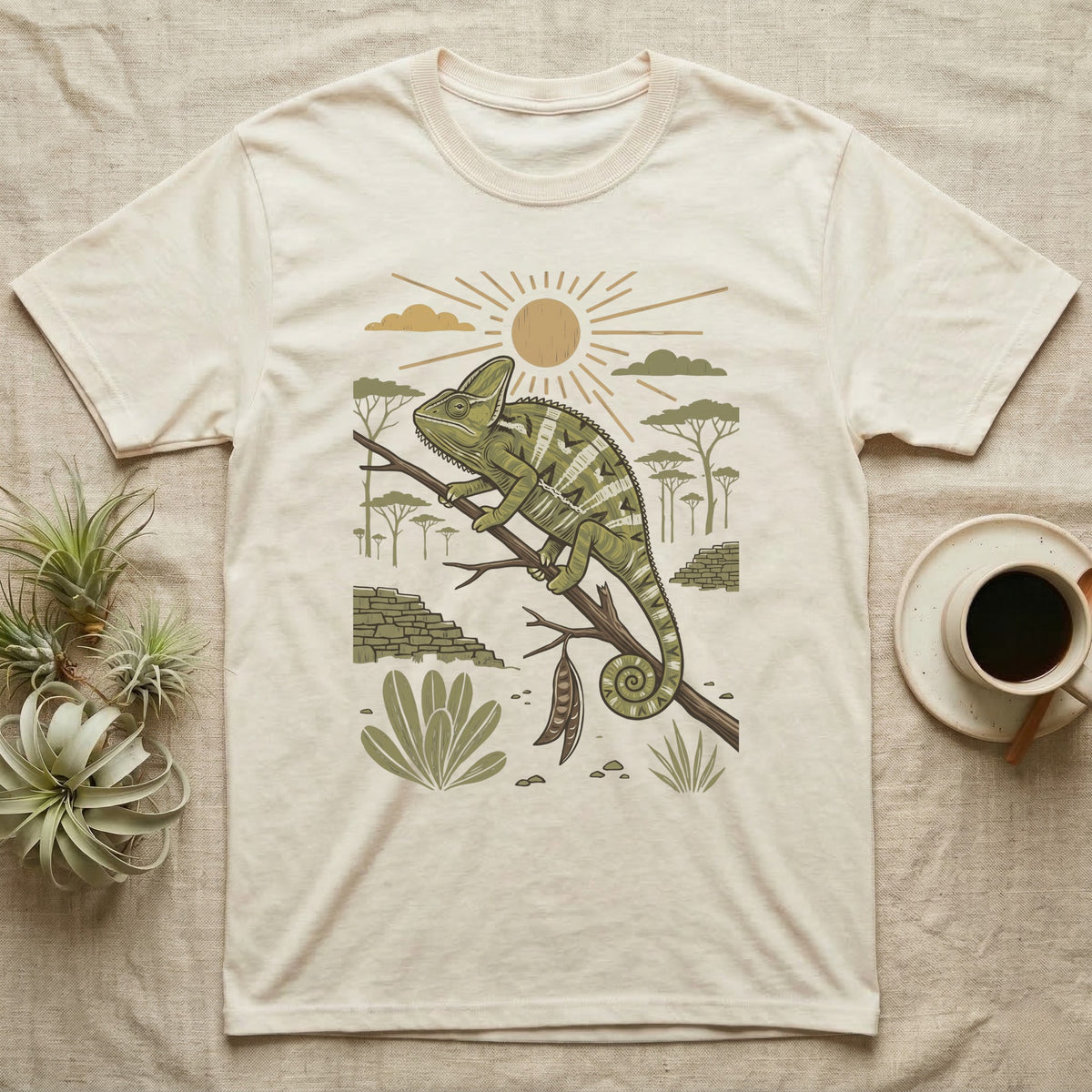 Veiled Chameleon Home Range T-Shirt in Natural — Woodcut-style illustration of a veiled chameleon gripping an acacia branch with terraced walls and umbrella trees behind, no on-shirt text.