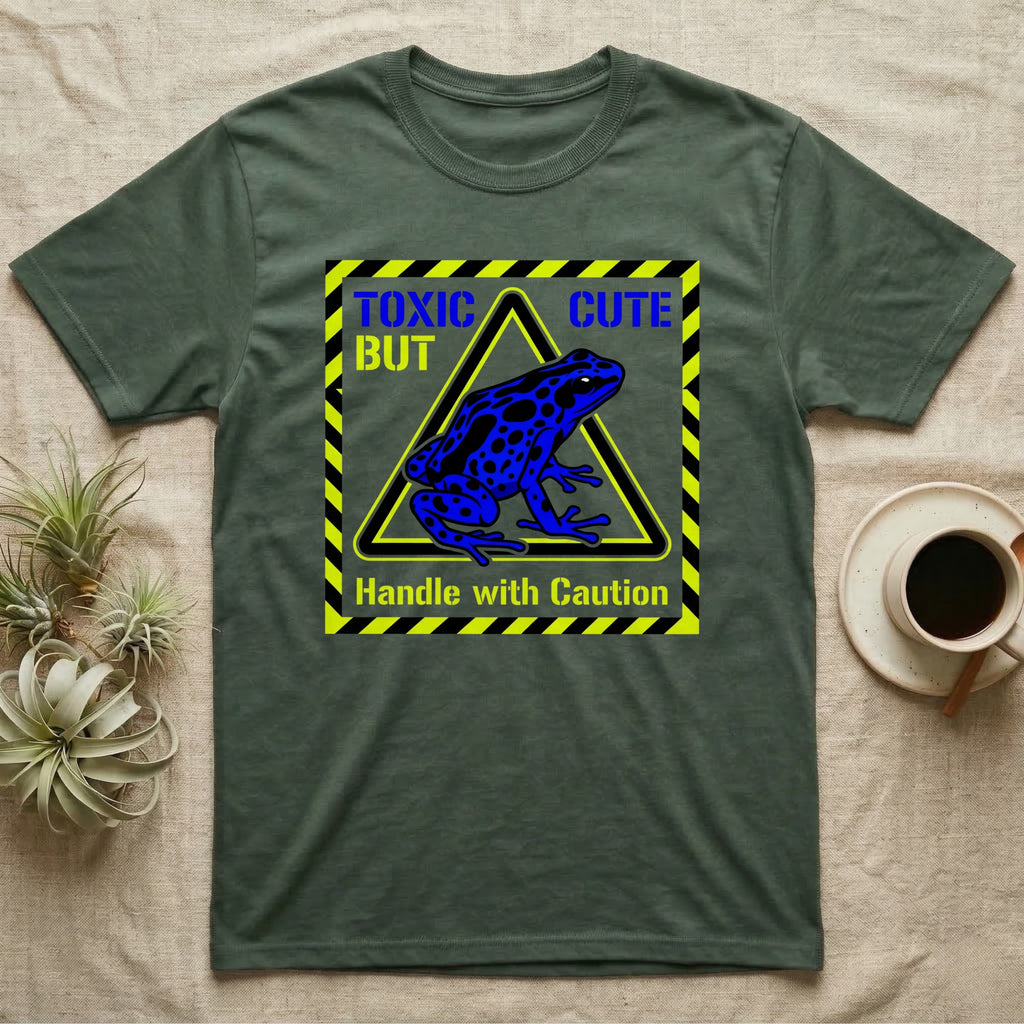 Green t-shirt with blue frog graphic and "TOXIC CUTE Handle with Caution" text.