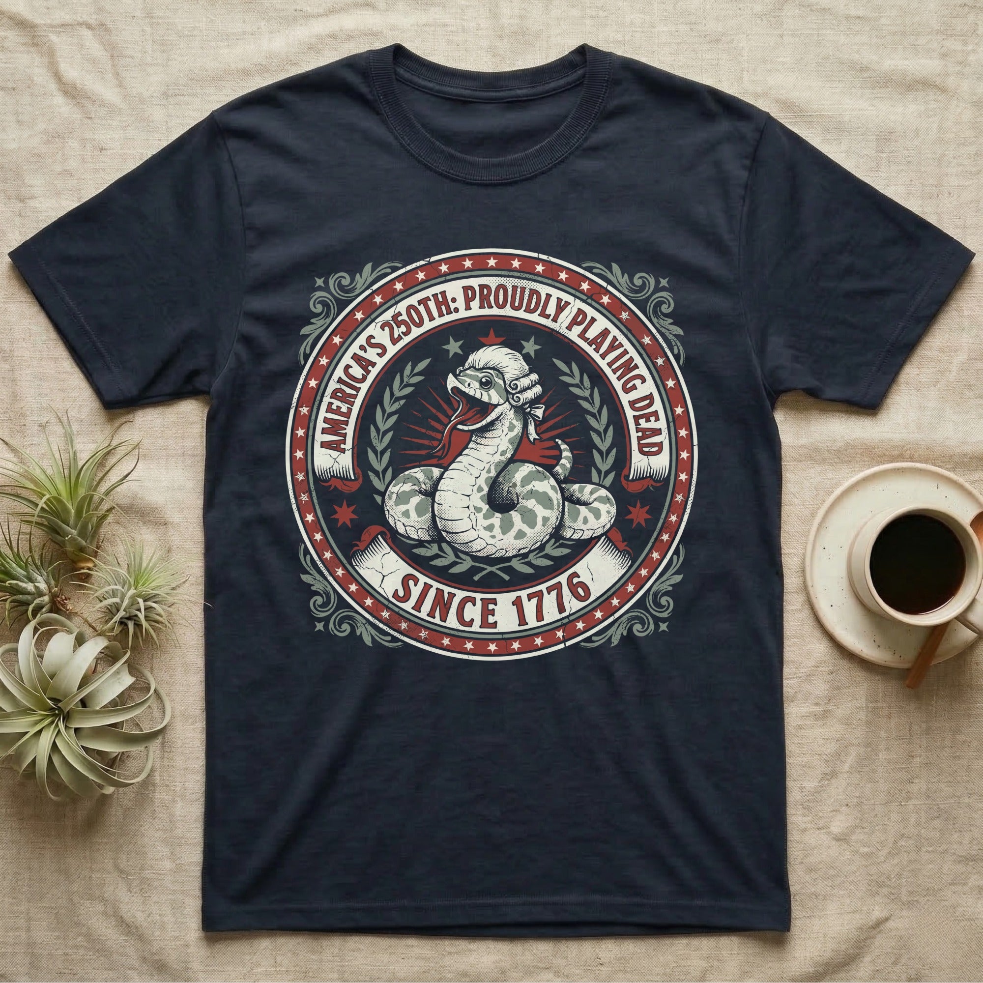 Hognose Snake 1776 Tee in Navy — Vintage circular seal of a hognose snake playing dead belly-up in a colonial wig, brick-red and cream emblem reading Proudly Playing Dead Since 1776.