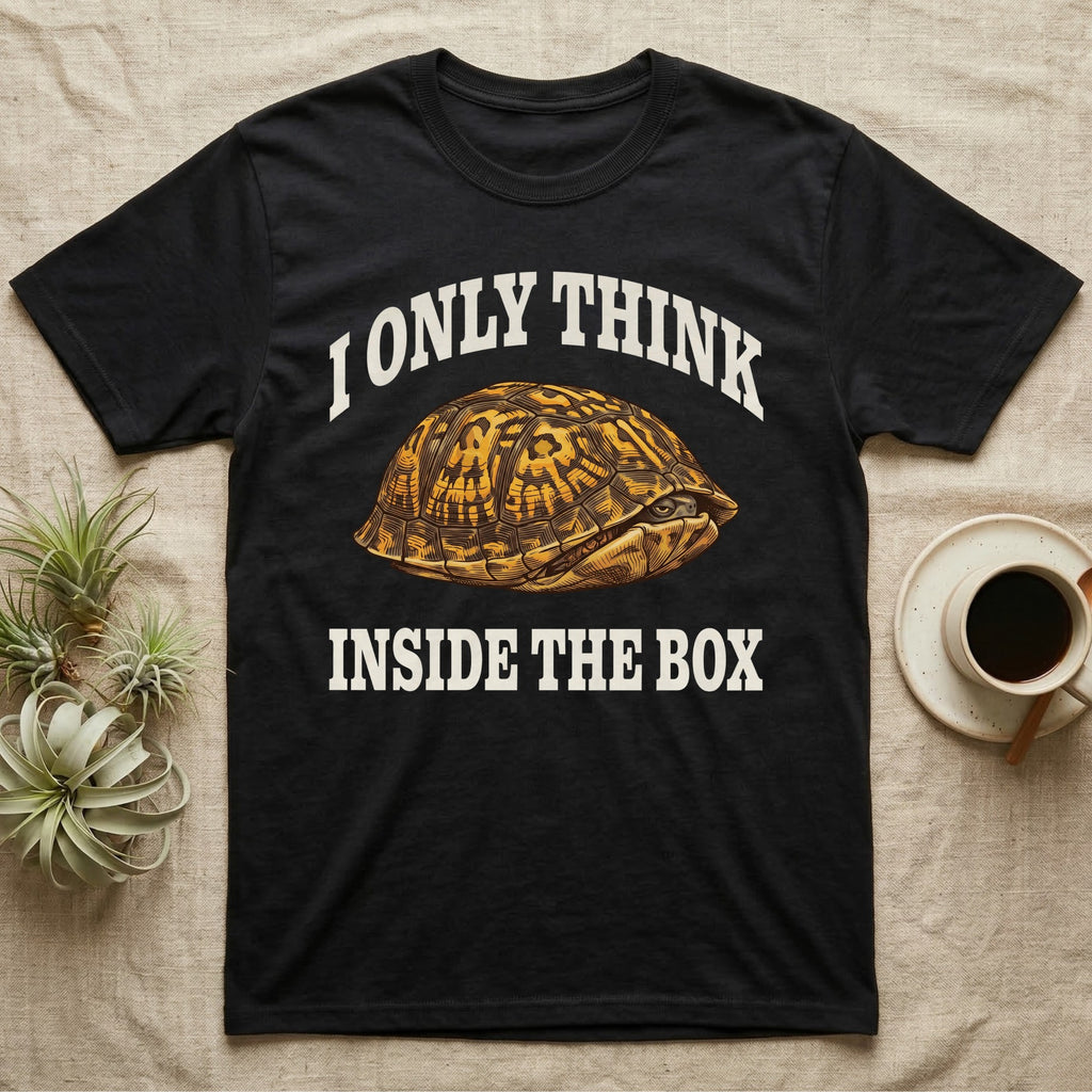 Box Turtle Thinker T-Shirt in Black — Engraved eastern box turtle shut in its shell, one eye peeking out, under I Only Think Inside the Box