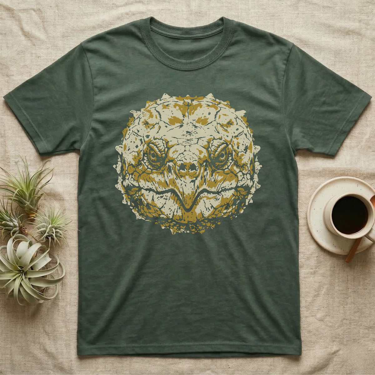 Alligator Snapper Face T-Shirt in Military Green — Two-ink stencil of an alligator snapping turtle face, head-on, hooked beak closed, olive-gold eyes on black.
