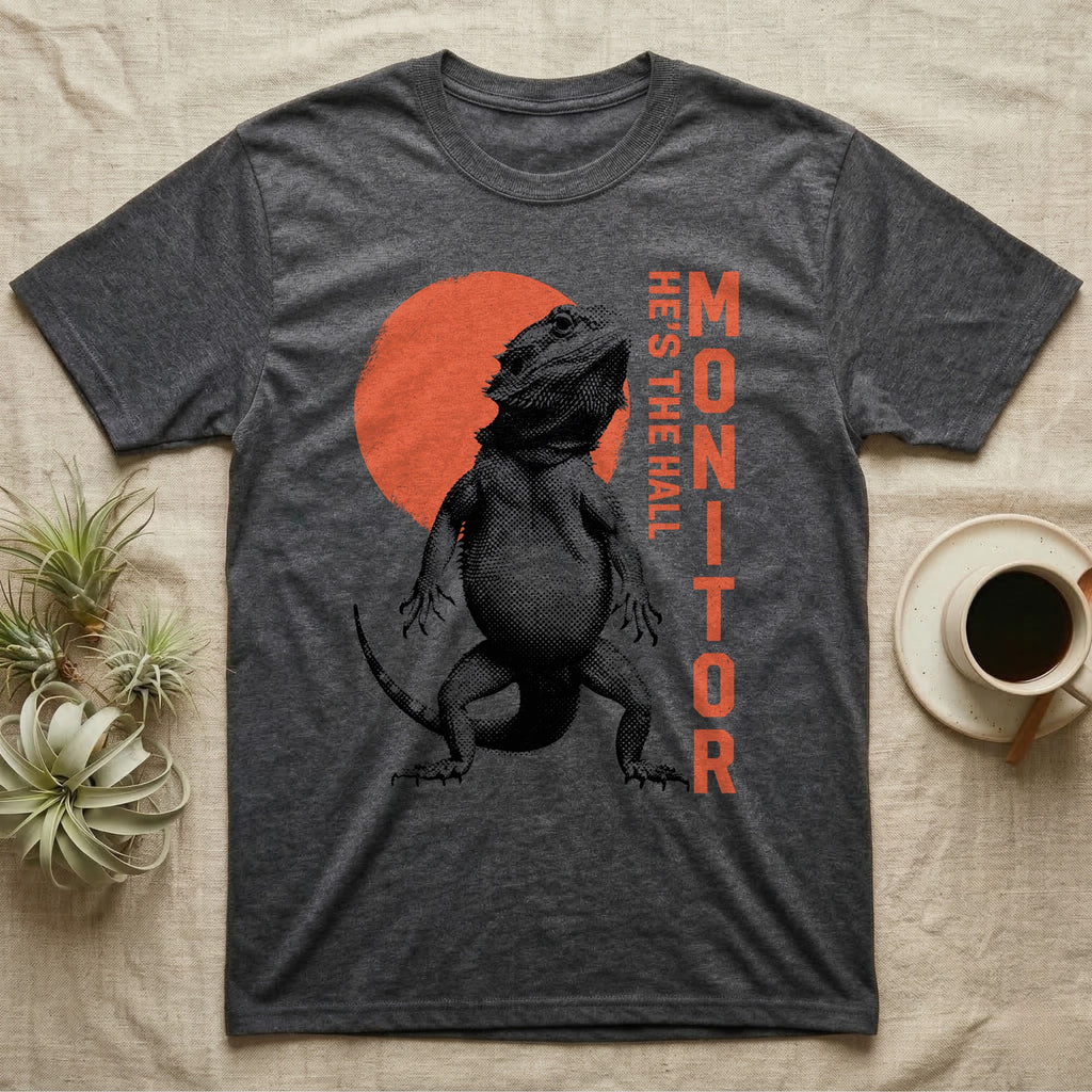 Bearded Dragon Hall Monitor T-Shirt in Dark Heather — Coarse halftone illustration of a bearded dragon mid-stride, a distressed vermilion disc behind and HALL MONITOR alongside.