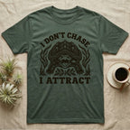 Alligator Snapper Lure T-Shirt in Military Green — Folk-print alligator snapping turtle, jaws open, tongue lure out, a fish swimming in, text I Don't Chase I Attract