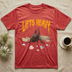 Rhino Beetle Feral T-Shirt in Heather Red — Horned rhinoceros beetle standing head-on below a dripping amber-gold metal "Lifts Heavy" wordmark