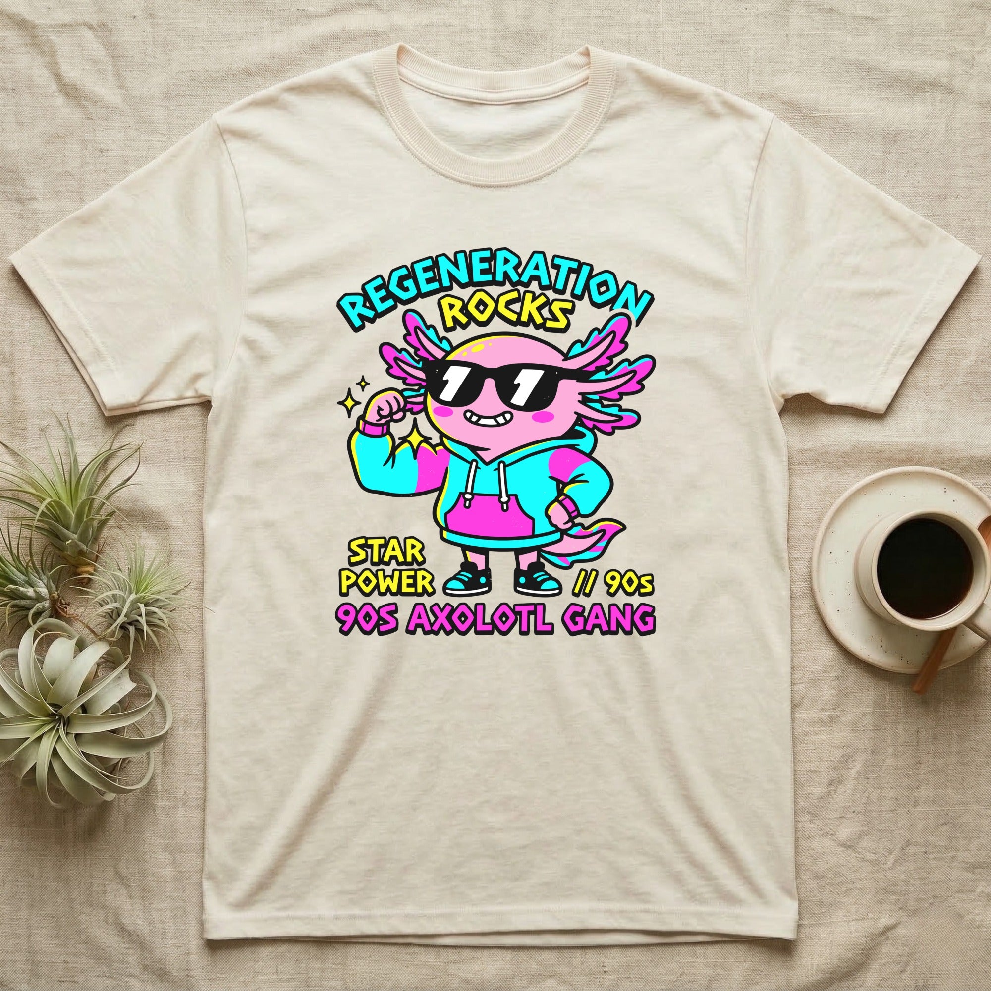 Axolotl Regeneration Rocks T-Shirt in Natural — Neon 90s cartoon pink axolotl in shades flexing under "Regeneration Rocks" lettering.