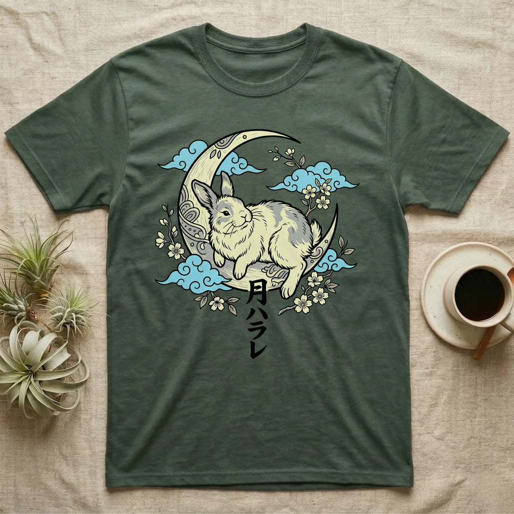 Green t-shirt with a rabbit on a crescent moon, surrounded by clouds and flowers.