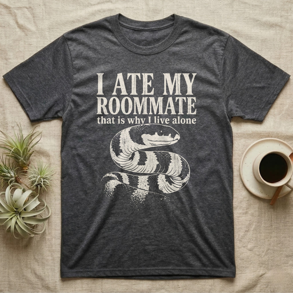California Kingsnake Ate My Roommate T-Shirt in Dark Heather — One-ink white California kingsnake portrait on black, black-and-cream banding, under the words I ATE MY ROOMMATE and that is why I live alone.