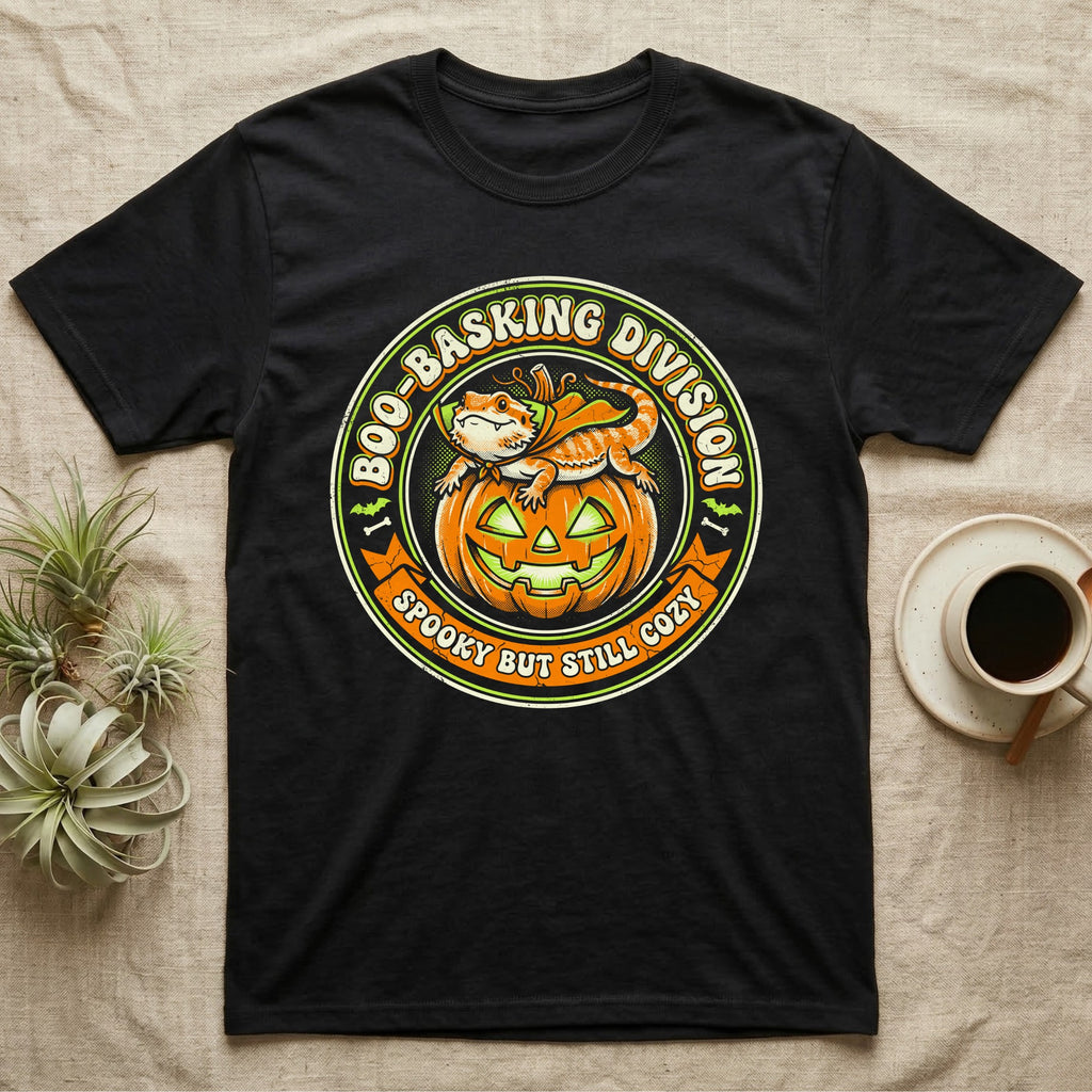 Bearded Dragon Boo-Basking T-Shirt in Black — Retro badge of a caped bearded dragon on a green-glowing pumpkin, "Boo-Basking Division, Spooky But Still Cozy."