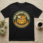 Bearded Dragon Boo-Basking T-Shirt in Black — Retro badge of a caped bearded dragon on a green-glowing pumpkin, "Boo-Basking Division, Spooky But Still Cozy."