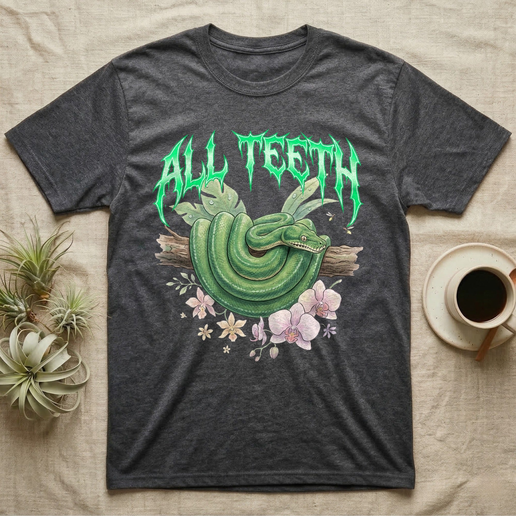 Emerald Tree Boa Feral T-Shirt in Dark Heather — Coiled emerald tree boa on a branch below a dripping emerald-green metal "All Teeth" wordmark