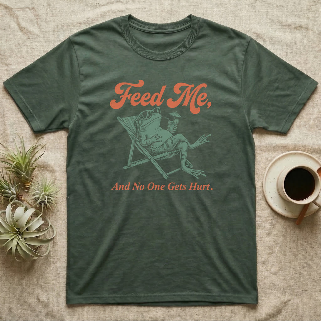 American Bullfrog Beach Chair T-Shirt in Military Green — Illustrated American bullfrog lounging in a beach chair with sunglasses and a tropical drink, coral script reading Feed Me And No One Gets Hurt.