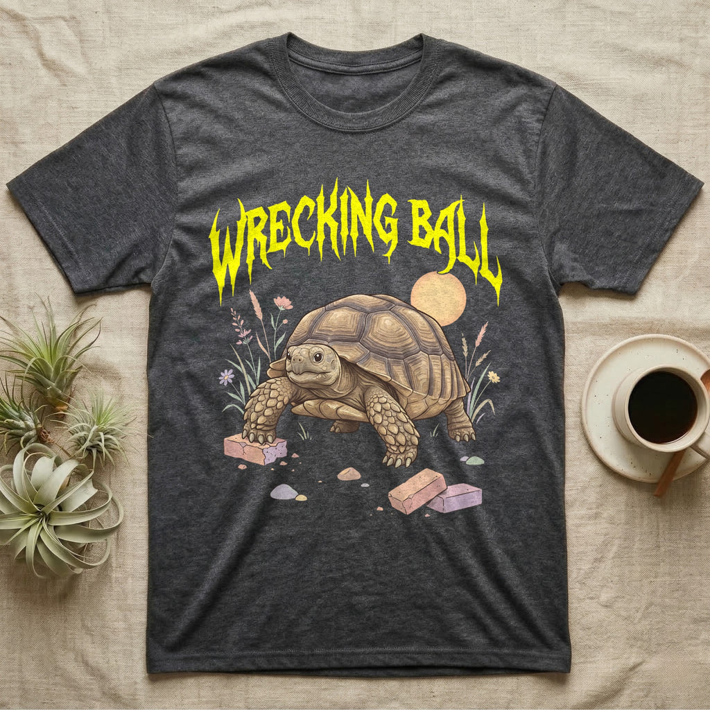 Sulcata Tortoise Feral T-Shirt in Dark Heather — Sulcata tortoise plodding over crumbled bricks under a jagged caution-yellow metal "WRECKING BALL" wordmark.