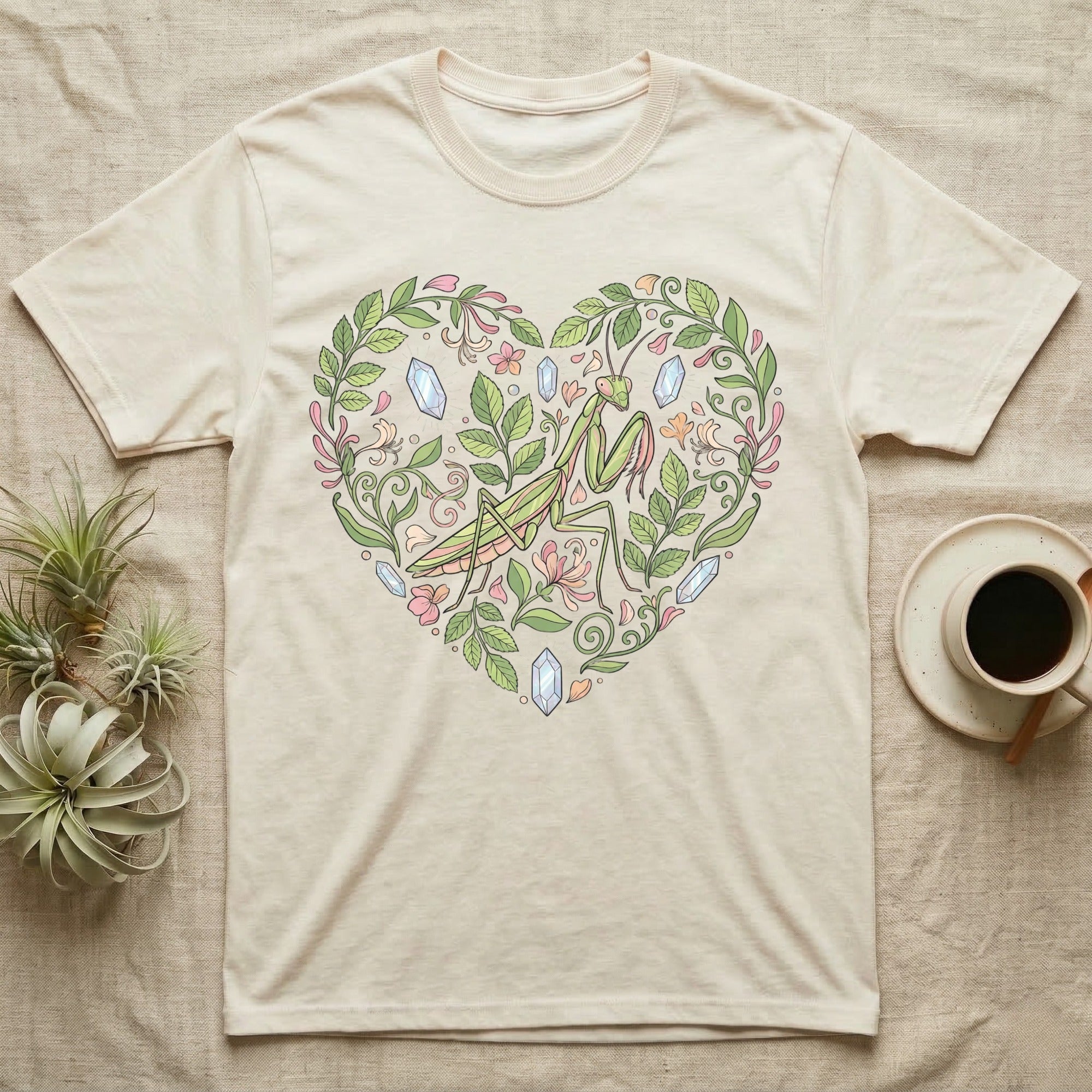 T-shirt with a heart-shaped floral design featuring a praying mantis and crystals.