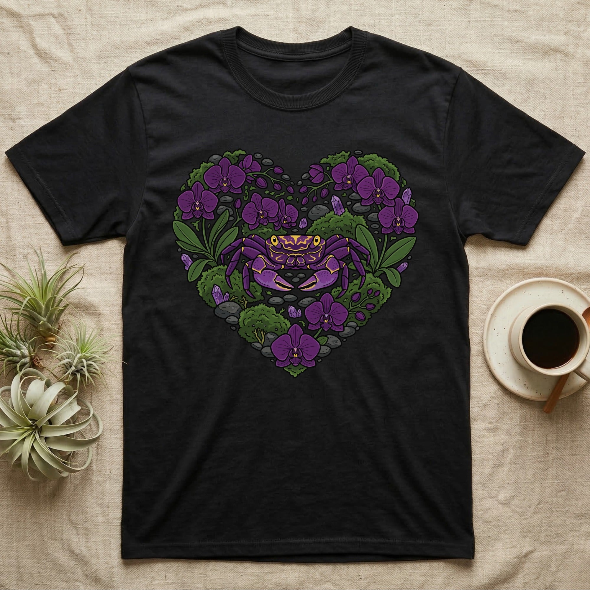 Black t-shirt with a purple crab and purple orchids forming a heart shape.
